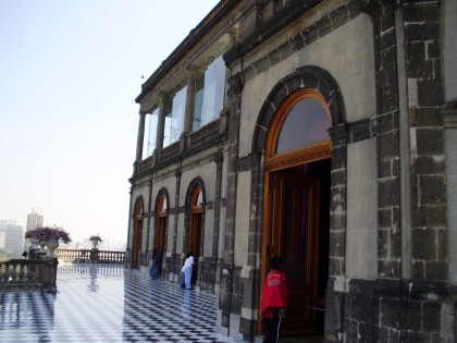 People seeing exhibits through the doors of the Alcázar at Chapultepec Castle.